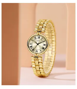 Detail of GEDI vintage gold watch featuring a round Roman numeral dial and link strap
