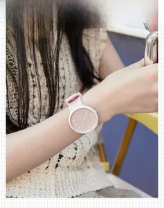 Close-up of GEDI pink silicone quartz watch featuring a large minimalist dial on a wrist
