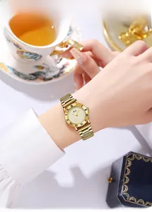 Close-up of vintage gold ladies watch with Roman numeral bezel and metal bracelet