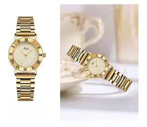 Detail view of Gedi gold metal watch with Roman numeral bezel and cream minimalist dial