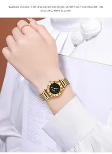 Detail of gold quartz watch with black Roman numeral dial worn on a female wrist