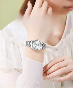 Detailed close-up of a silver stainless steel quartz watch with a sunburst dial texture