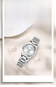 Close-up of diamond-cut silver steel watch with rhinestone dial and pearl decoration