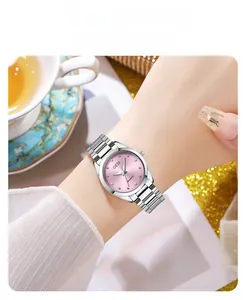 Detail view of GEDI silver quartz watch with a light pink dial on a female wrist