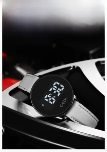 Macro shot of the GEDI digital watch featuring a gray strap and a black LED display