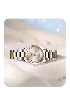 Macro detail of sunburst dial with crystal markers on gold and silver steel watch