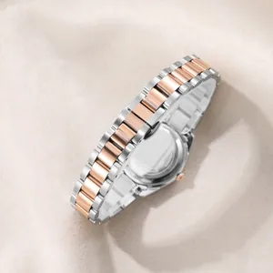 Elegant two-tone stainless steel watch band and back case on soft beige fabric