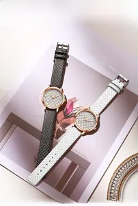Flat lay of luxury women's quartz watches in black and white leather with rose gold case