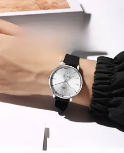 Detailed close-up of a GEDI quartz watch with silver sunray dial and black strap on wrist
