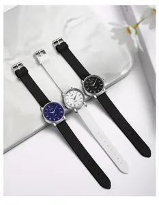 Detailed view of minimalist quartz watches with silicone straps in black and white colors