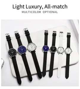 Detailed view of multicolor waterproof quartz watches with silicone bands on marble surface