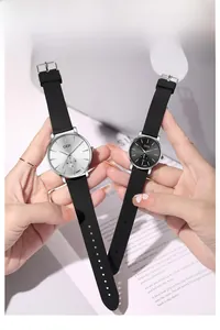 Detail of minimalist couple watches with black silicone straps and small second dials