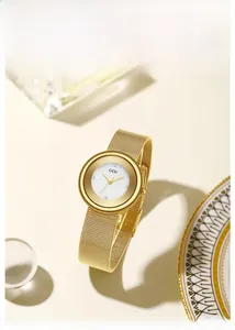 Detailed shot of a gold mesh strap watch with a white dial and sparkling crystal indices