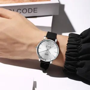 Minimalist GEDI quartz watch with silver dial and black silicone strap on wrist