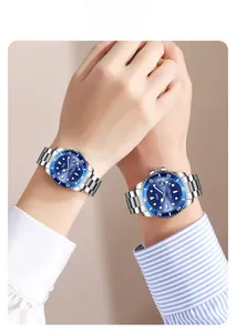 Close-up of GEDI couple watches with blue dial and steel strap on hands