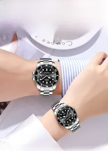 Close-up of couple quartz watches with silver steel bands and black sunburst dials