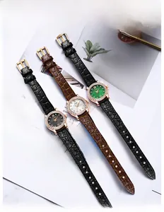 Luxurious quartz watches with leather straps and rhinestone bezels on vintage magazine