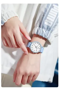 Close-up of light blue silicone strap watch with cartoon bear dial on a wrist
