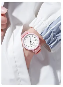 Close-up of pink silicone watch featuring a cartoon bear and clear numeric markers