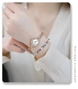 Close-up of rose gold watch with rhinestones and matching infinity gem bracelet