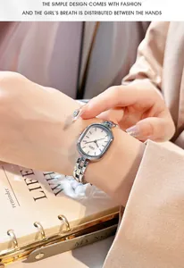 Elegant oval mother-of-pearl dial watch with silver chain strap on a female wrist