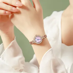 Elegant rose gold women's watch with rhinestone bezel and purple gradient dial