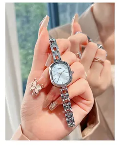 Detail of elegant silver bracelet watch with a mother-of-pearl oval dial on a female wrist