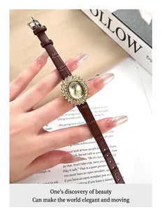 Nahaufnahme einer eleganten Gold-Quarzuhr mit Kristalllünette und braunem Lederarmband