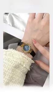 Detail of GEDI women's watch featuring a blue mother of pearl dial and gold metal case