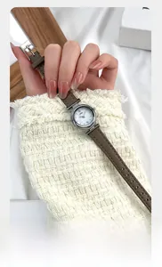 Close-up of elegant quartz watch with mother of pearl dial and brown leather strap