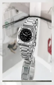 Detailed view of square silver steel watch with black dial and polished decorative screws
