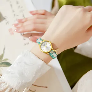 Elegant Chinese style women watch with gold case, floral strap and whale tail charm