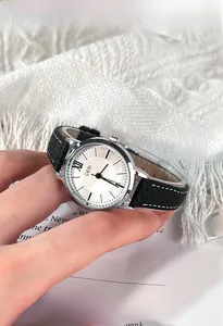 Close-up of GEDI vintage ladies watch with black leather strap and silver round dial