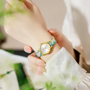 Elegant GEDI women watch with floral fabric strap and golden fish tail charm pendant