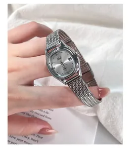 Close-up of elegant silver quartz watch with mesh band and diamond-studded dial