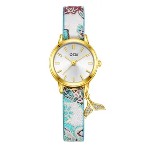 Women's quartz watch with gold fishtail pendant and colorful jacquard fabric strap