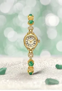 Detail of luxury vintage jade style watch with gold metal band and green gemstones