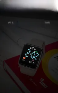 Close-up of a digital sports watch with LED display and soft beige silicone strap