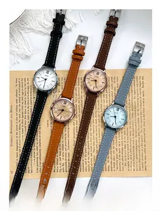 Detailed view of GEDI retro quartz watches with leather straps on vintage newspaper