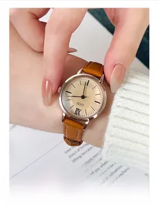 Close-up of elegant GEDI women's quartz watch with brown leather strap and gold dial