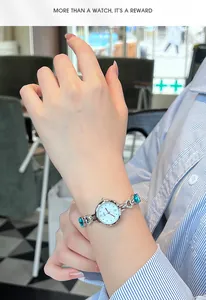 Close-up of elegant women's jewelry watch with blue gems on a model's wrist