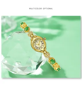 Close-up of gold quartz watch with jade-like beads and sparkling coin-shaped links