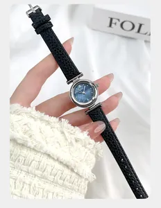 Close-up of small quartz watch with blue sunray dial and black litchi leather strap