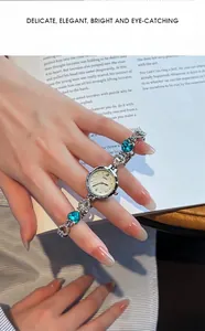 Detailed view of silver bracelet watch with heart-shaped blue stones and crystal accents