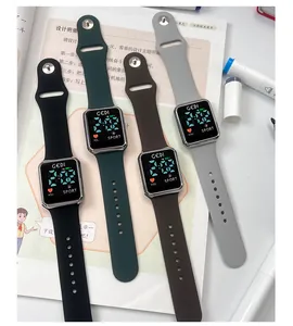 Four digital watches with square metal frames and soft silicone bands in assorted colors
