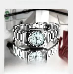 Macro shot of silver octagonal dial watch with steel strap and date window on reflective surface