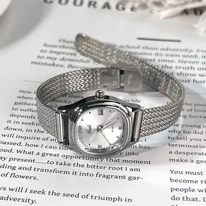 Gedi elegant silver women's quartz watch with date display and mesh strap on a magazine