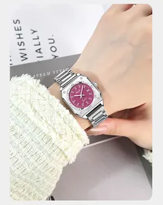 Detail view of square magenta dial watch with date window and silver steel band