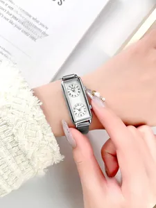 Detail view of a vintage rectangular dual-dial quartz watch with silver mesh band