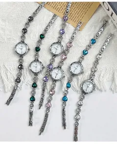 Detailed row of vintage luxury quartz watches with heart-shaped gemstones in multiple colors